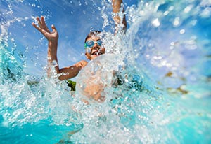 child swimming in pool